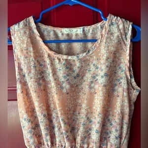 Light pink sleeveless dress with floral design, elastic waist